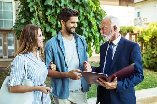 Couple chatting with Realtor. 