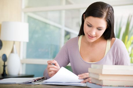 Young woman reviewing paperwork.