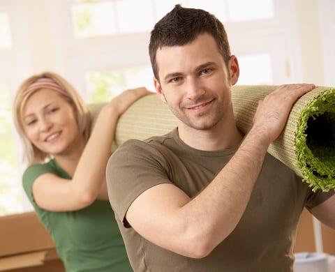 Couple carrying a carpet