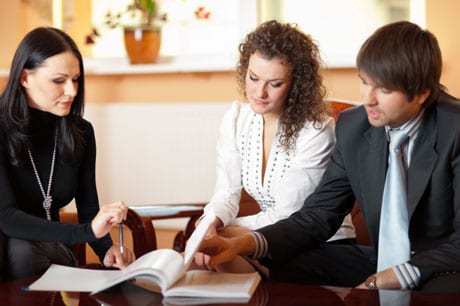 Couple with real estate agent.