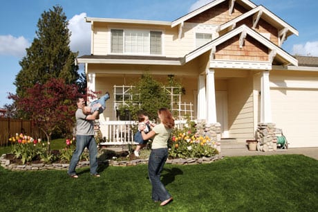 Couple playing with kids in the yard.